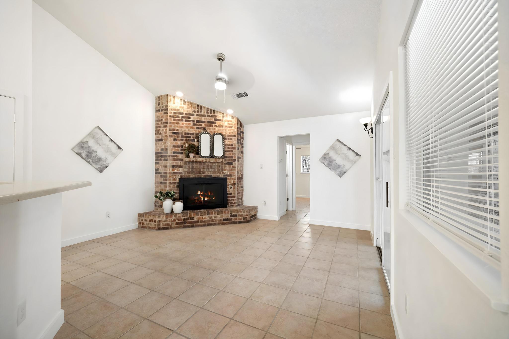 2614 Howellwood Way, Unit B Austin, TX 78748 - Photo 7 of 24 a view of an empty room with fireplace and a window
