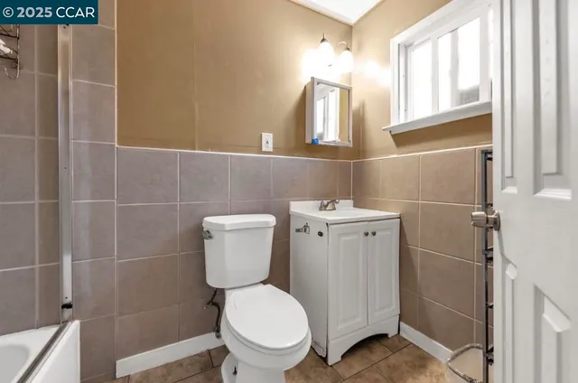 a white toilet sitting next to a bathroom sink