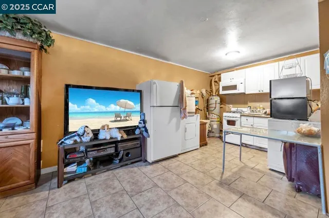 a kitchen with refrigerator and cabinets