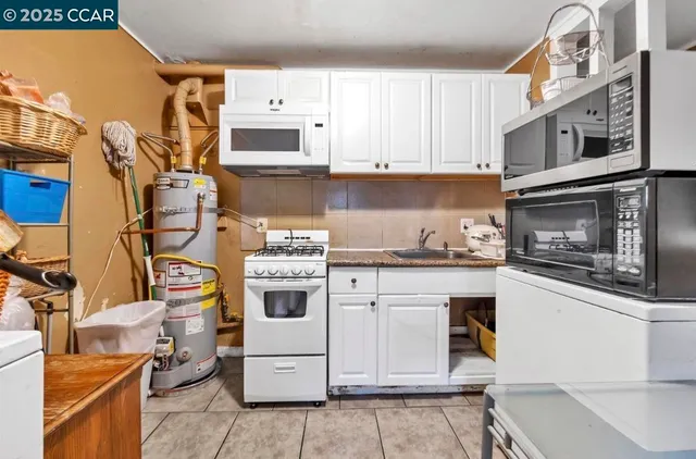a kitchen with stainless steel appliances a stove a microwave and cabinets
