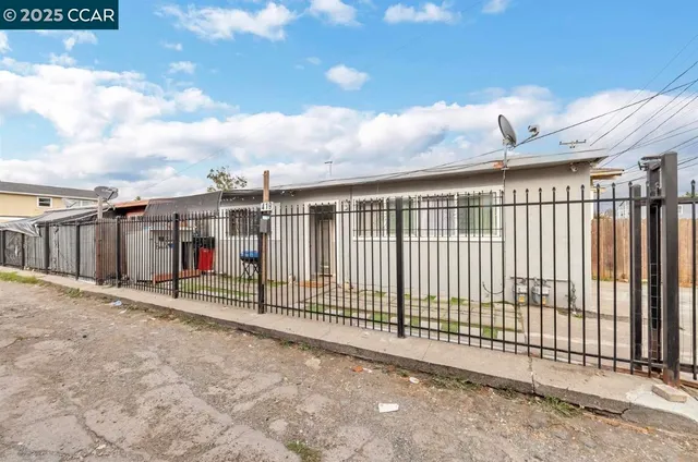 a view of a wrought iron fences in front of house
