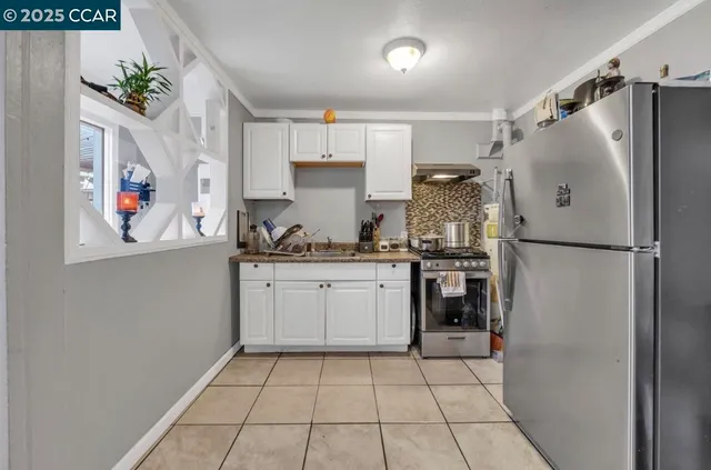 a kitchen with a refrigerator and cabinets