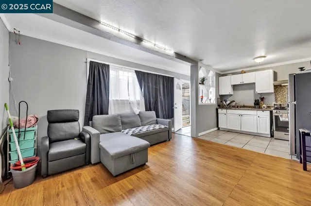 a living room with furniture and kitchen view