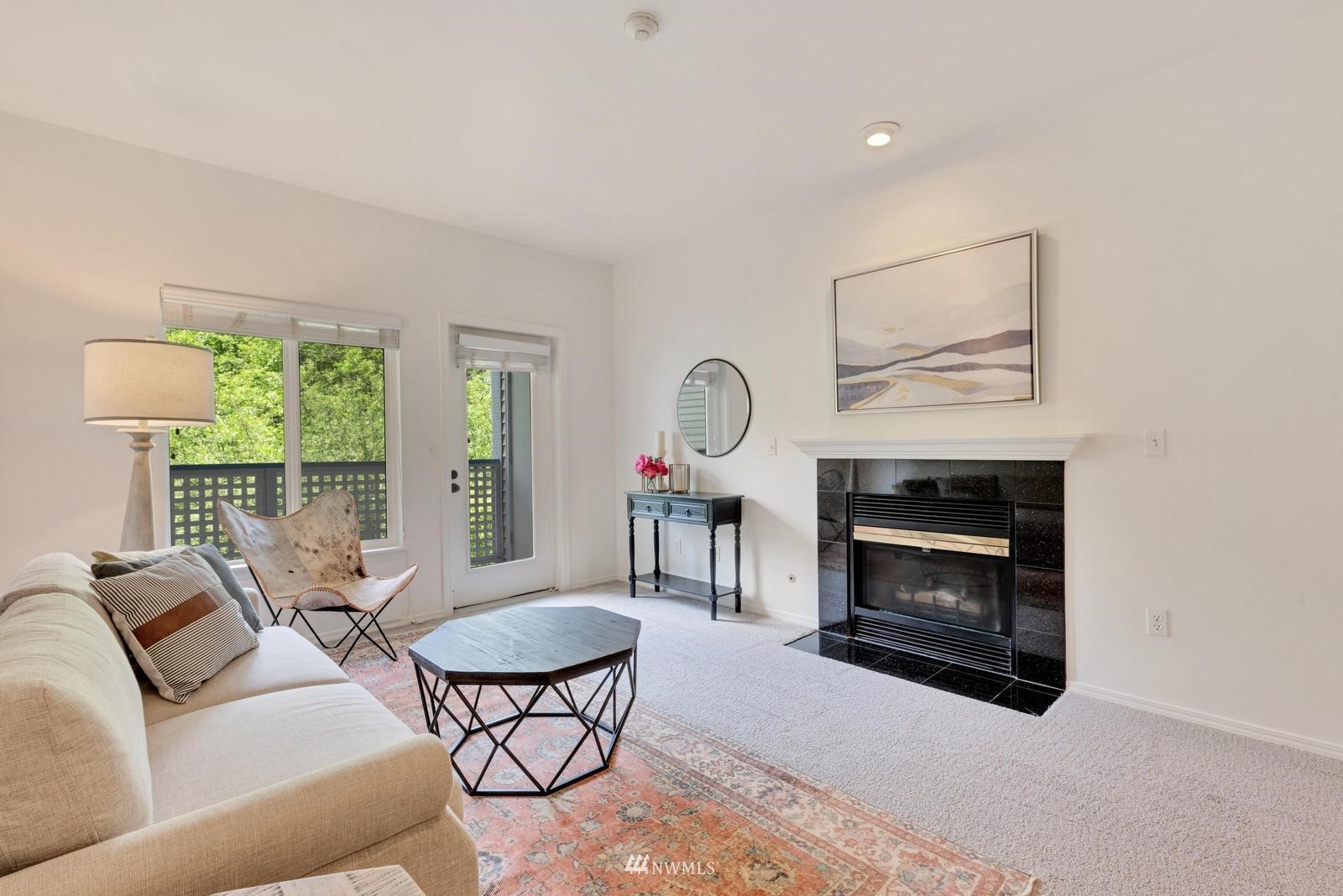 a living room with furniture a window and a fireplace