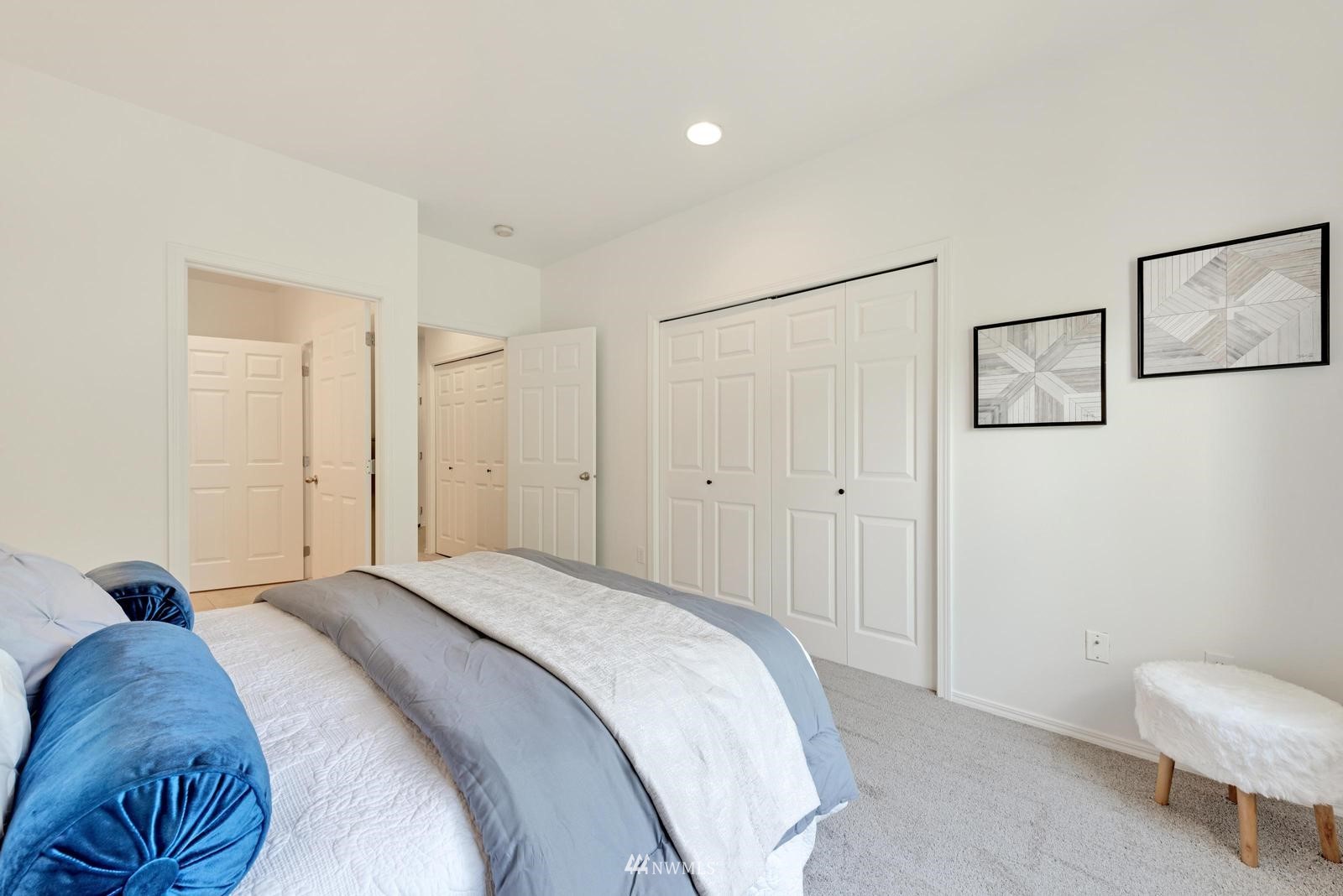 23908 Bothell Everett Highway, Unit D203 Bothell, WA 98021 - Photo 12 of 15 a bed room with a bed and a chair