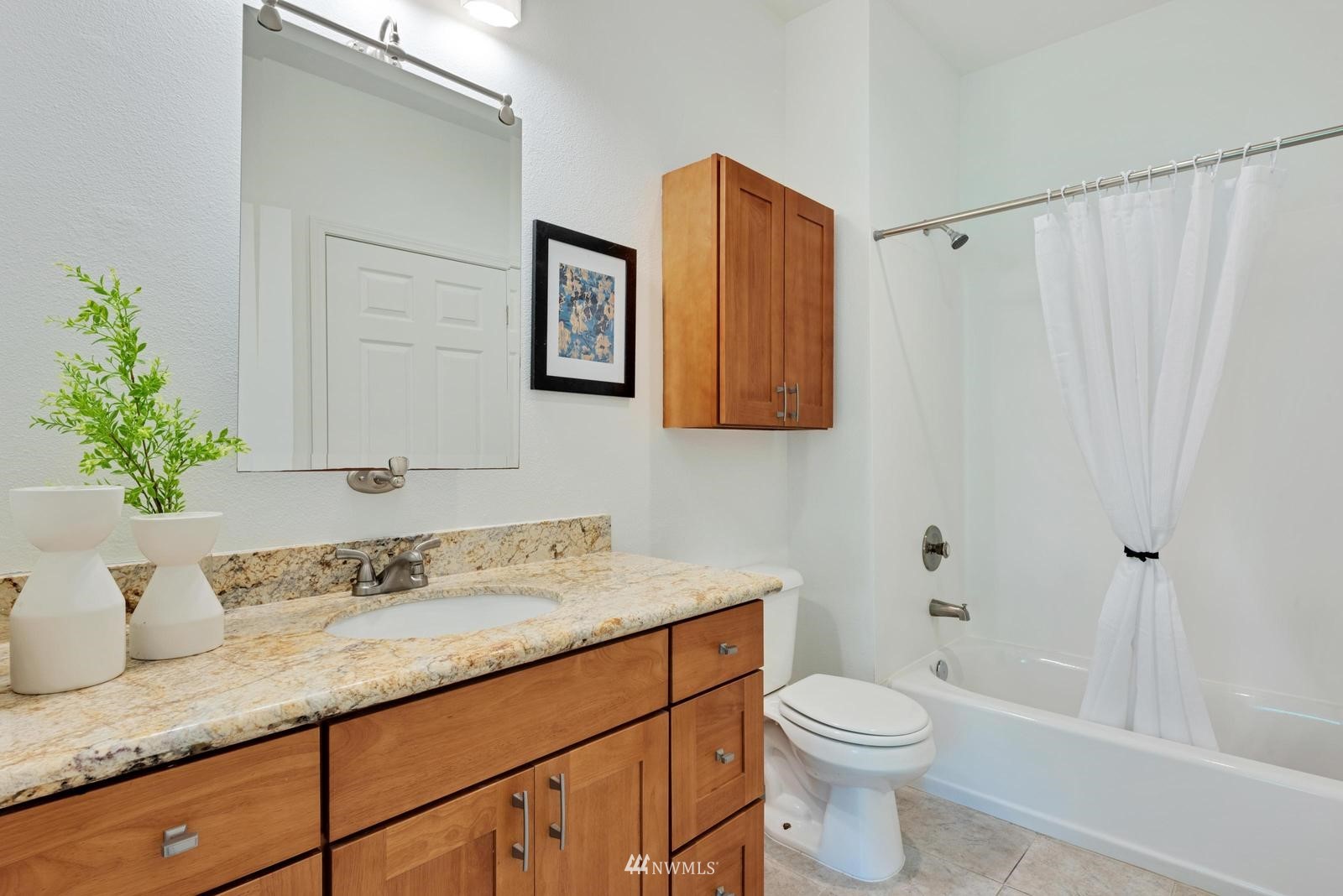 23908 Bothell Everett Highway, Unit D203 Bothell, WA 98021 - Photo 13 of 15 a bathroom with a sink a toilet and shower