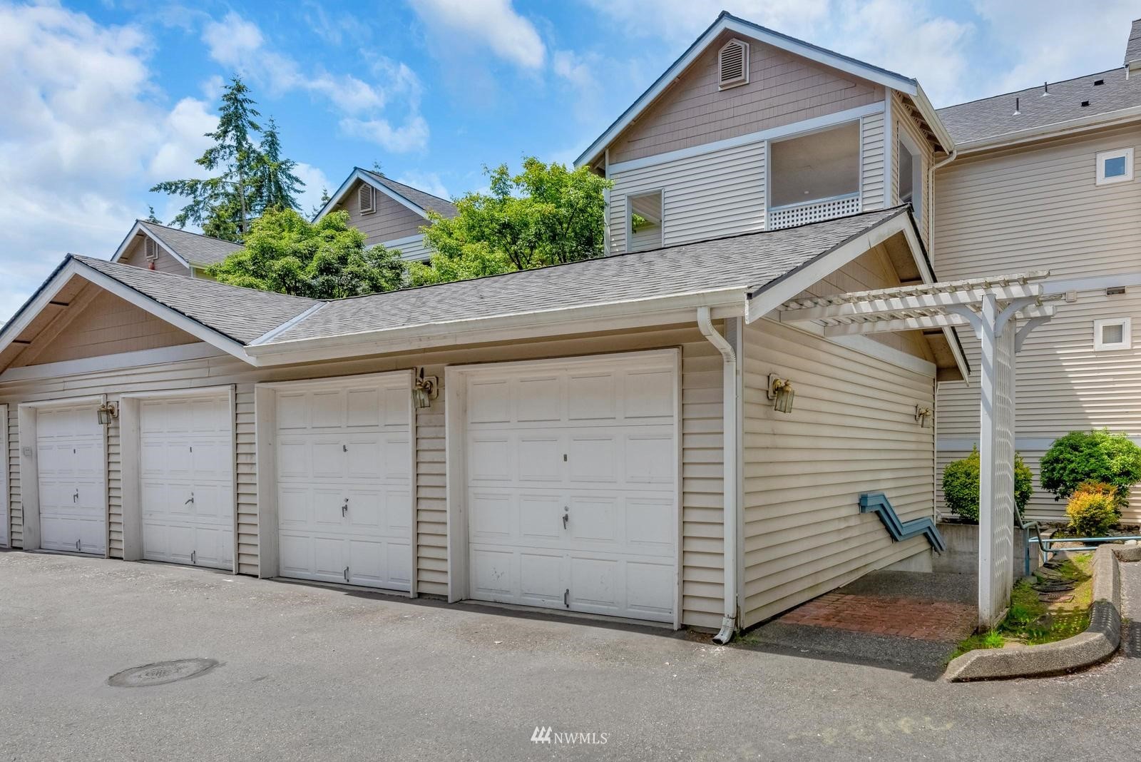 23908 Bothell Everett Highway, Unit D203 Bothell, WA 98021 - Photo 2 of 15 a view of a house with garage