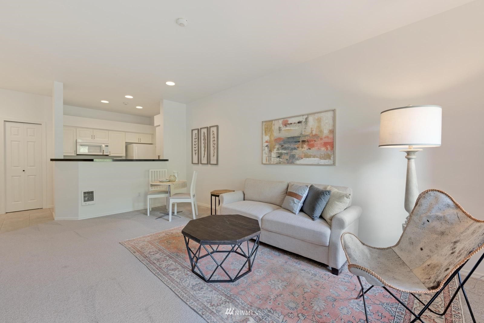23908 Bothell Everett Highway, Unit D203 Bothell, WA 98021 - Photo 6 of 15 a living room with furniture and a lamp