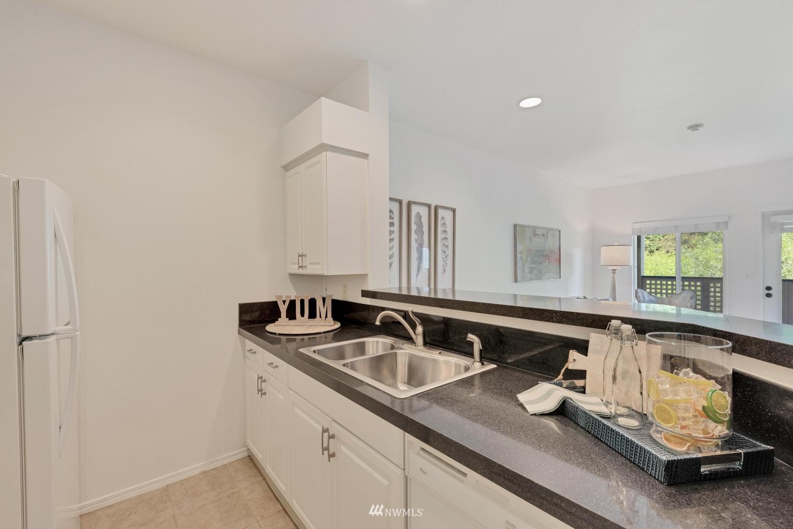 23908 Bothell Everett Highway, Unit D203 Bothell, WA 98021 - Photo 9 of 15 a kitchen with a sink and a refrigerator