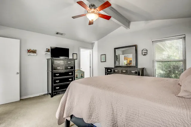 a bedroom with a bed and a television