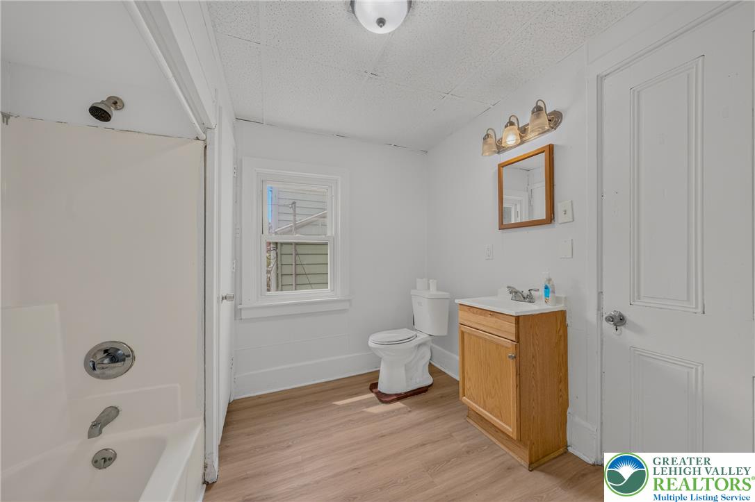 313 Main Street Slatington, PA 18080 - Photo 33 of 73 A well-lit bathroom features light wood-look flooring, a classic vanity, and a shower-tub combination.