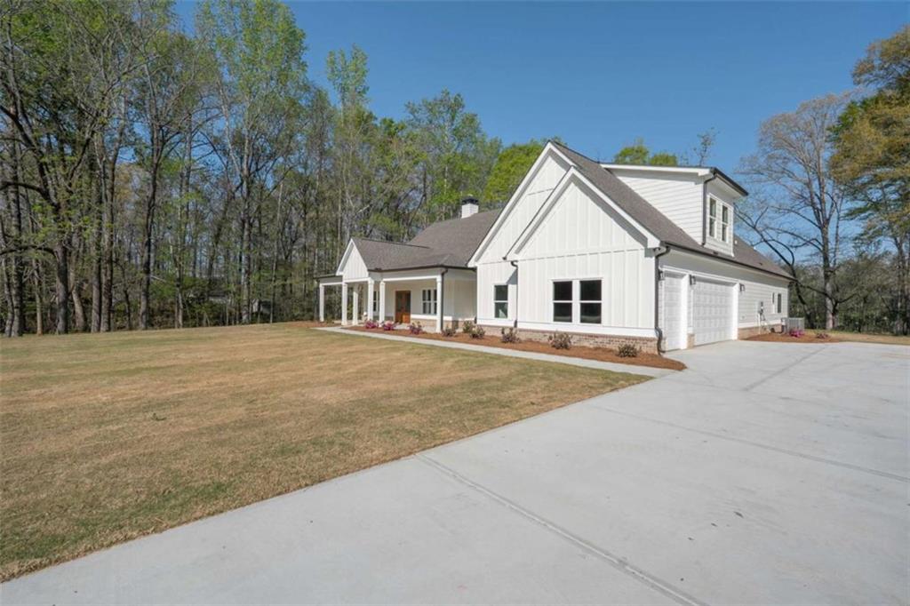 11691 Hazelbrand Road Northeast Covington, GA 30014 - Photo 3 of 53 a front view of a house with yard and trees