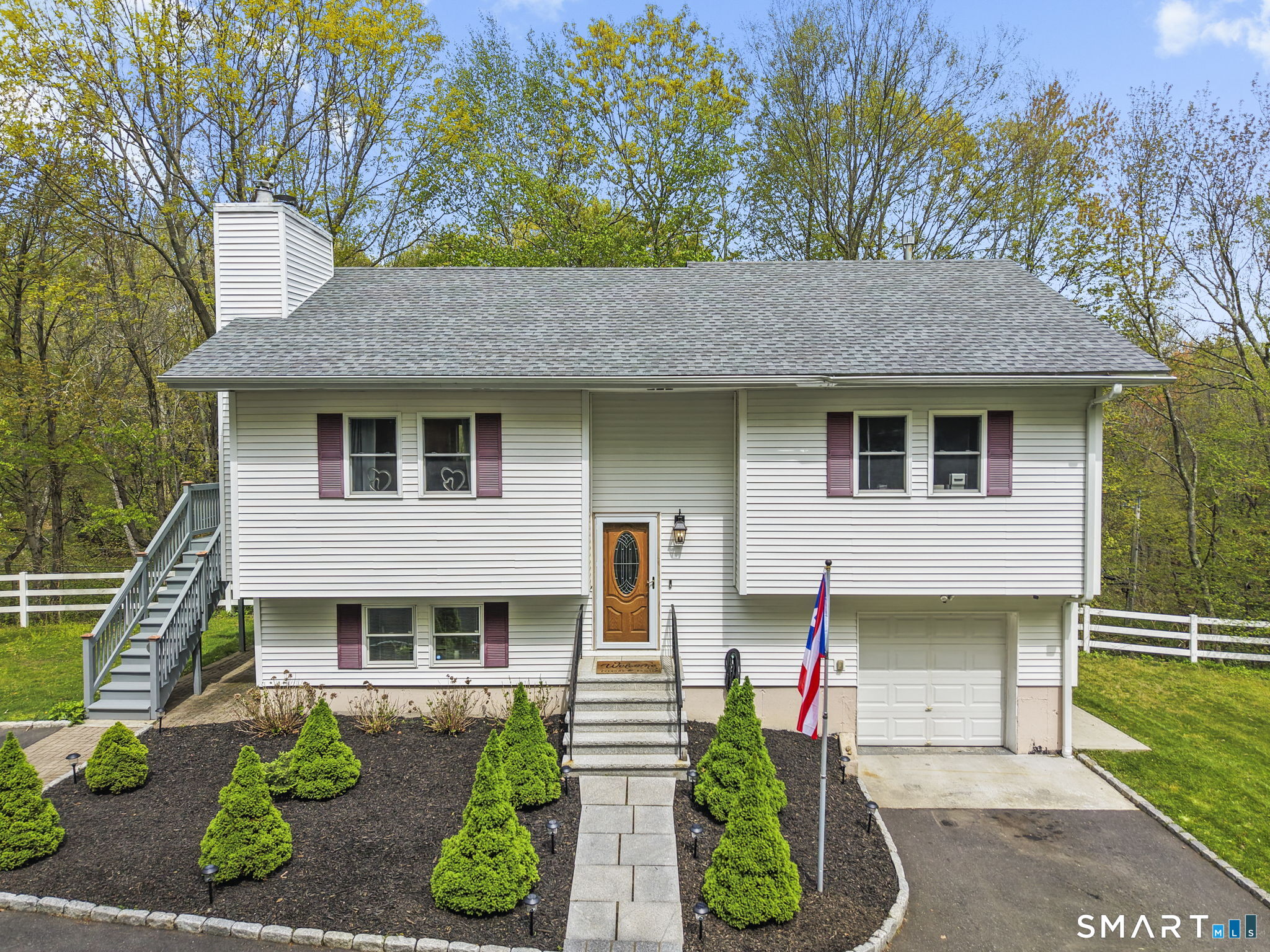 a front view of a house with garden