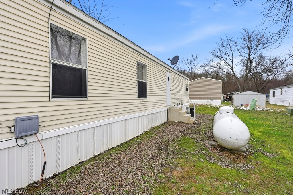 6507 Robby Lane Ravenna, OH 44266 - Photo 24 of 25 View of property exterior with a yard