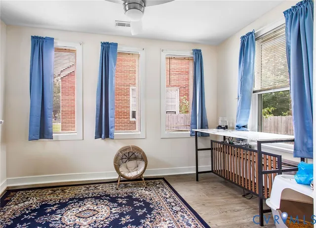 a view of an entryway with a window and wooden floor