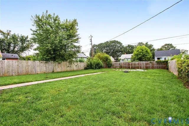 a view of green field with house in the background