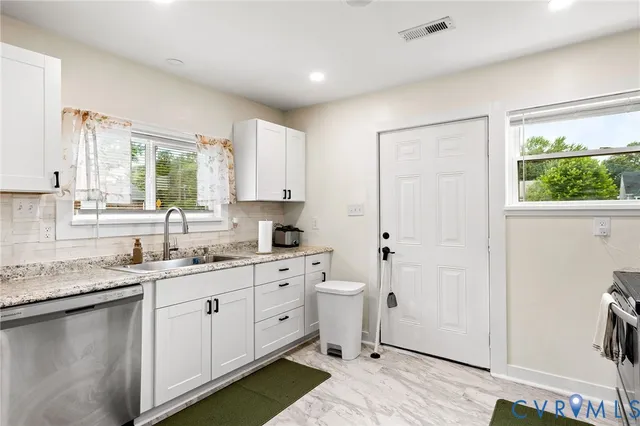 a kitchen with a sink cabinets and window