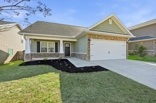 a front view of a house with a yard and garage