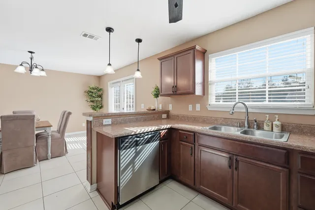 a kitchen with stainless steel appliances granite countertop a sink stove and cabinets