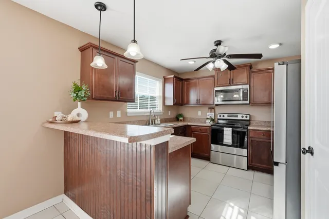 a kitchen with a sink stainless steel appliances and cabinets