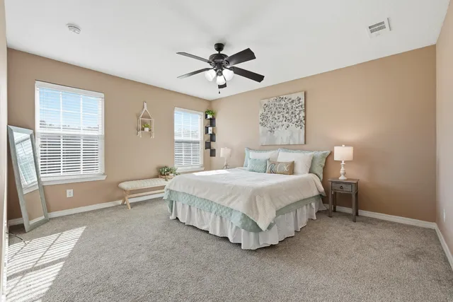 a spacious bedroom with a bed and a large window