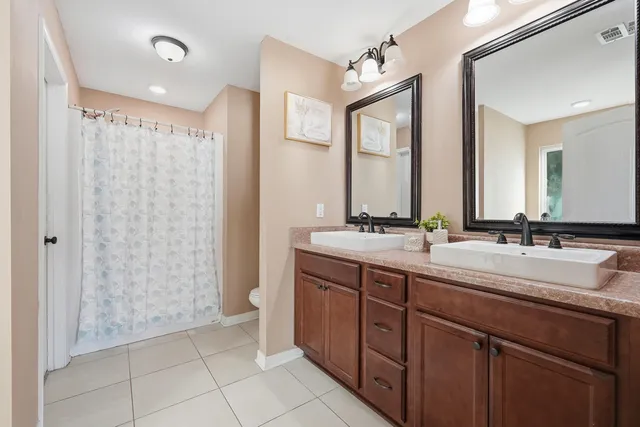 a bathroom with a double vanity sink mirror and double