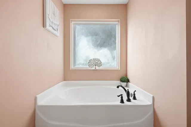 a white bath tub sitting in a bathroom