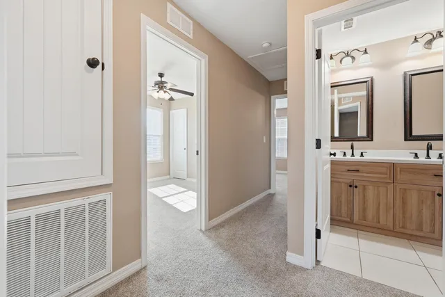 a bathroom with a double vanity sink toilet and shower