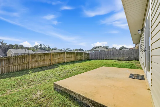 a view of a garden with a building in the background