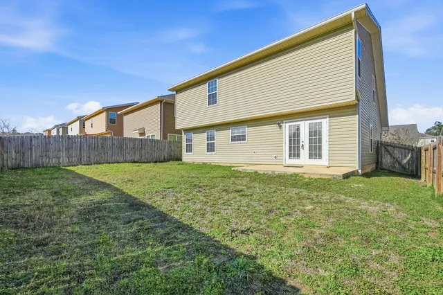 a view of a house with a backyard