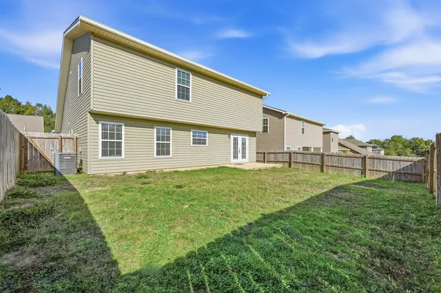 a view of a backyard with plants and a backyard