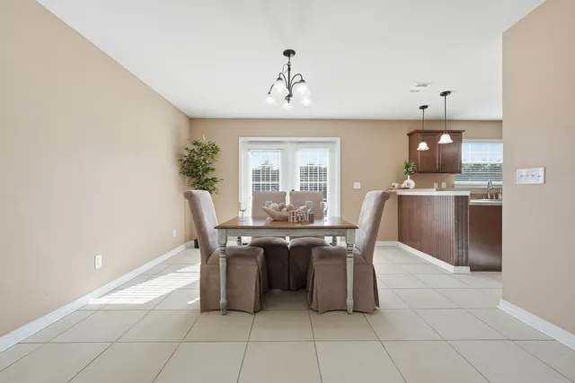 a view of a dining room with furniture and window