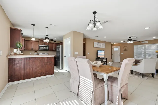 a large kitchen with a table and chairs
