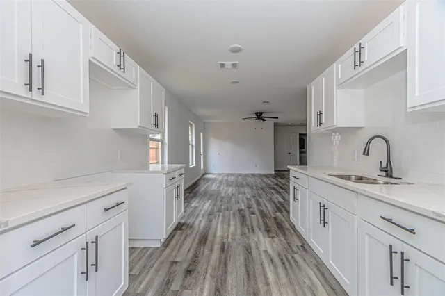 a kitchen with a sink and cabinets