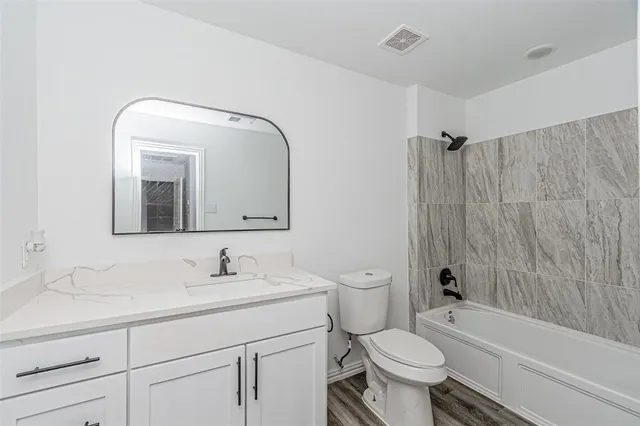 a bathroom with a toilet sink and a mirror