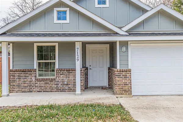 a front view of a house with a garage