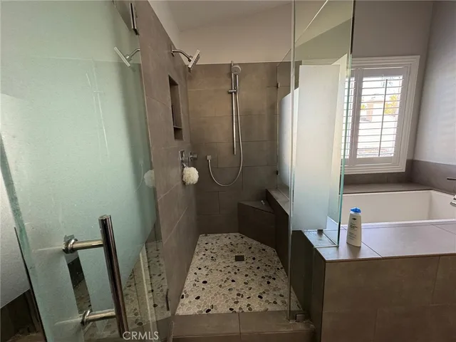 a bathroom with a bathtub a sink and a shower