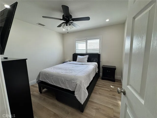 a bedroom with a bed and a ceiling fan
