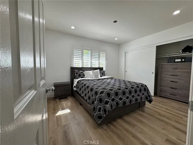 a bedroom with a bed and a mirror