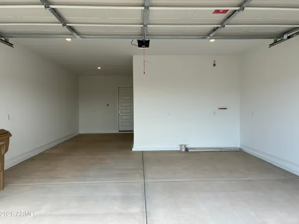 a view of a dry yard with wooden fence