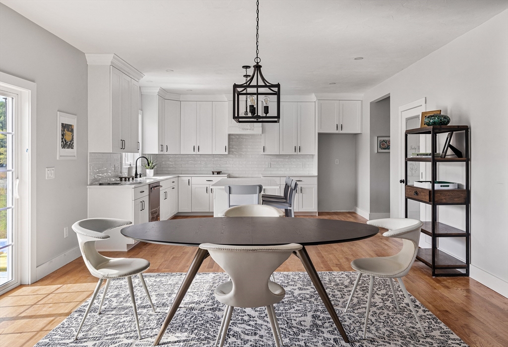 6 April Way Millis, MA 02054 - Photo 16 of 37 a kitchen with stainless steel appliances granite countertop a dining table chairs and granite counter tops