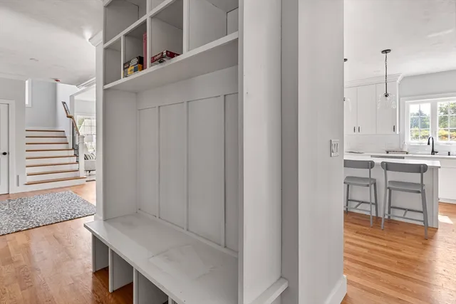 a kitchen with white cabinets and white appliances