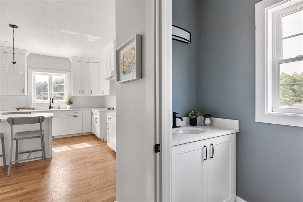 6 April Way Millis, MA 02054 - Photo 23 of 37 a kitchen with white cabinets and white appliances