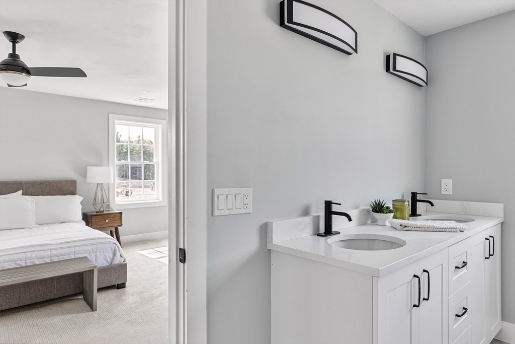 6 April Way Millis, MA 02054 - Photo 28 of 37 a bathroom with a sink and a mirror