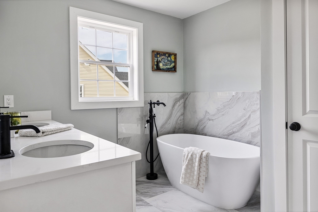 6 April Way Millis, MA 02054 - Photo 29 of 37 a bathroom with a sink and a bathtub