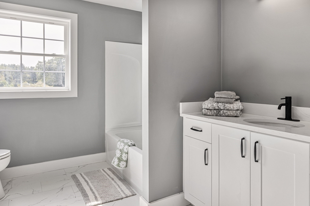 6 April Way Millis, MA 02054 - Photo 37 of 37 a bathroom with a sink toilet and window