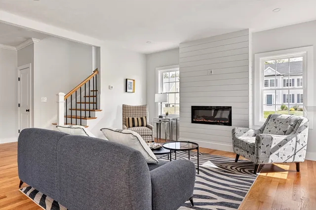 a living room with furniture a table and a fireplace