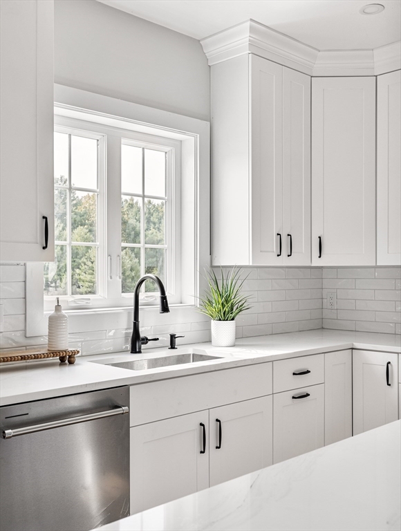 6 April Way Millis, MA 02054 - Photo 10 of 37 a kitchen with white cabinets a sink and a window