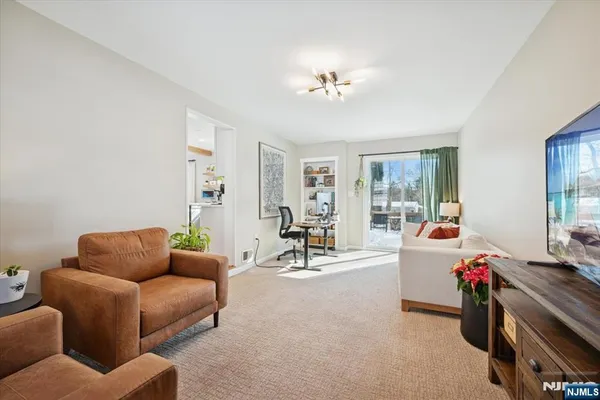 a living room with furniture and a chandelier