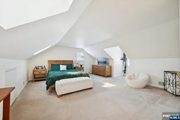 a spacious bedroom with a bed and a couch